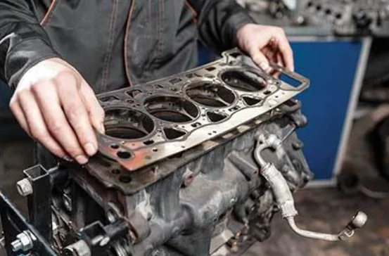 Professional installation of a high-performance head gasket kit on a heavy-duty diesel engine.