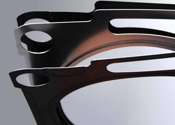 Professional installation of a high-performance head gasket kit on a heavy-duty diesel engine.