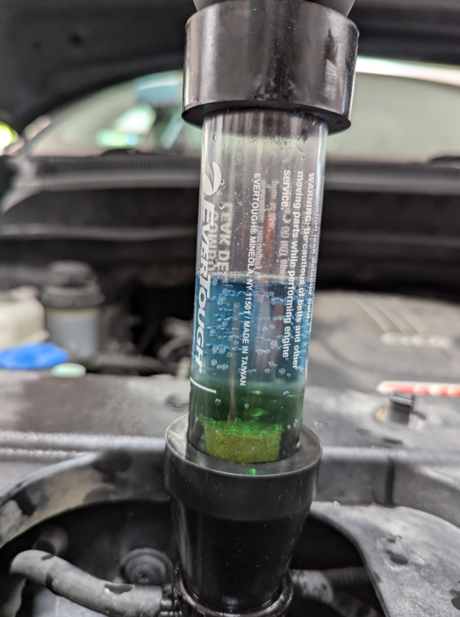 A chemical block test confirming combustion gases in the engine cooling system.