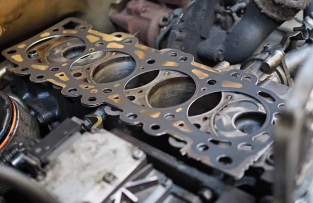 A mechanic explaining the valve cover gasket replacement cost to a customer.