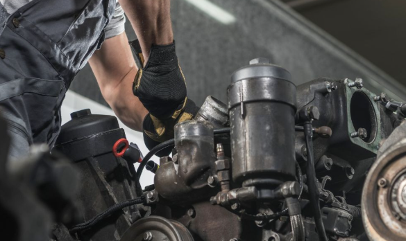A diesel mechanic installing a new valve cover gasket, emphasizing the professional labor involved.