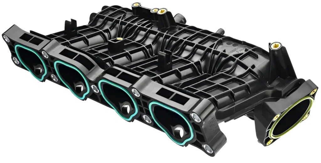 Professional mechanic working on a heavy-duty diesel engine intake manifold gasket replacement.