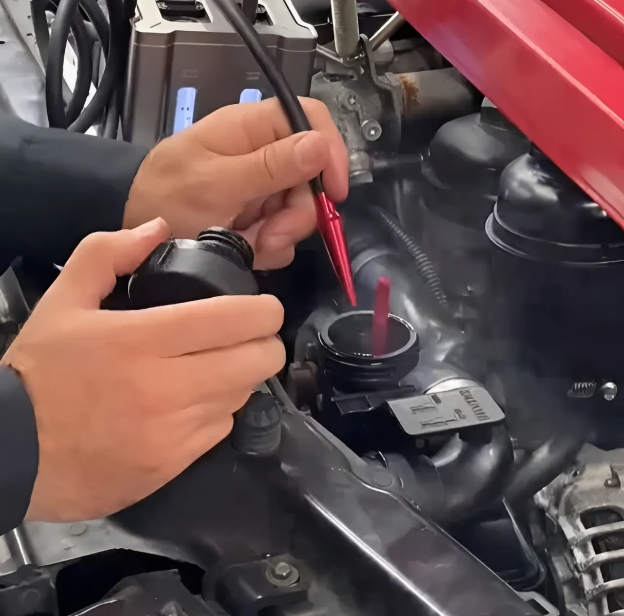 Mechanic diagnosing severe intake manifold leak symptoms using a smoke machine.