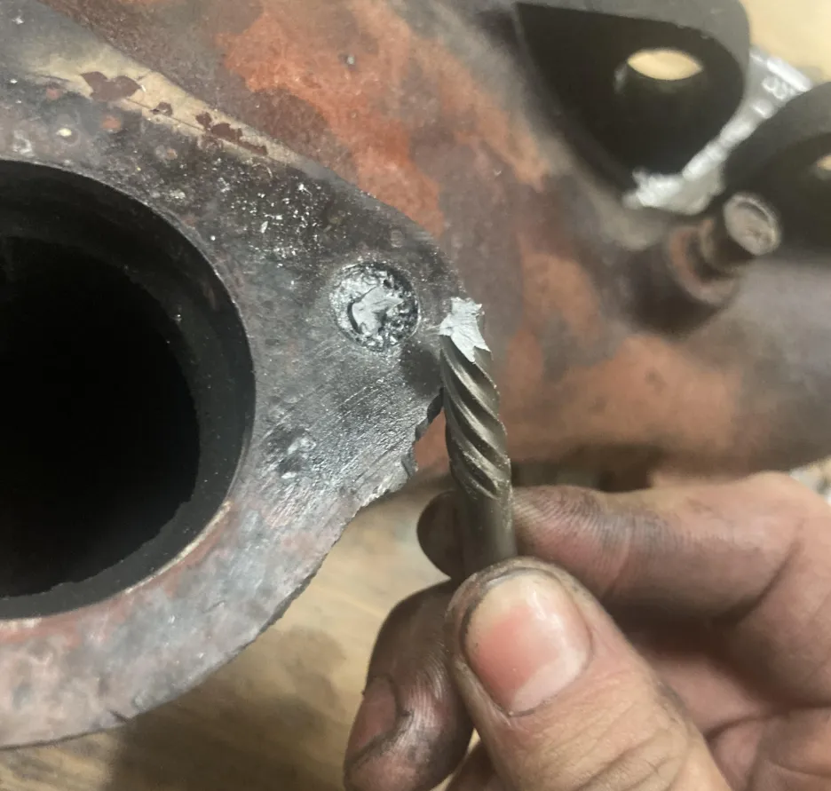 Commercial diesel engine teardown time extended due to extracting a broken exhaust manifold bolt.