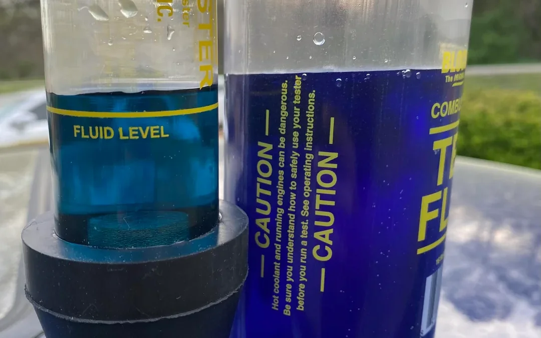 Head gasket test kit showing negative blue fluid and positive green fluid on a diesel engine.