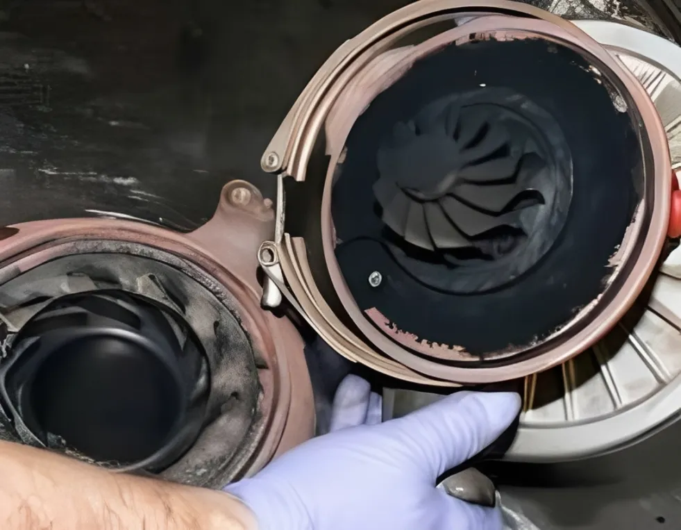 Mechanic repairing cummins x15 issues like EGR cooler failure and VGT turbo carbon buildup.