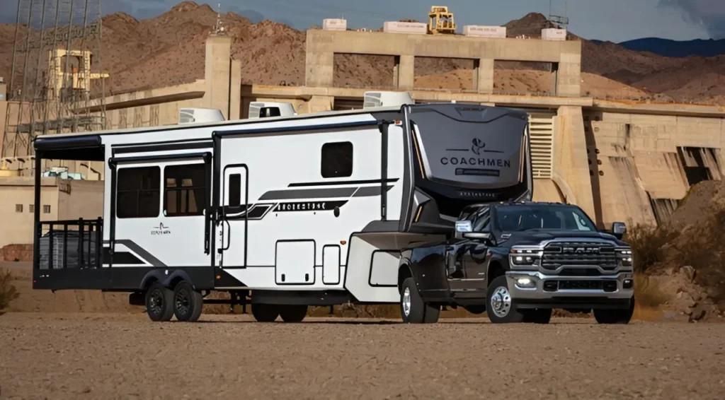 A heavy-duty Ram 2500 pickup truck towing a massive fifth-wheel trailer up a steep highway incline, demonstrating severe engine stress.