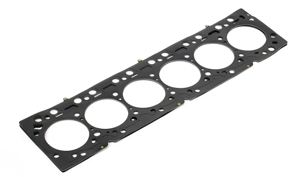 A close-up, high-resolution view of a Cummins ISX gasket kit, highlighting the multi-layer steel (MLS) structure and the black FKM rubber coating