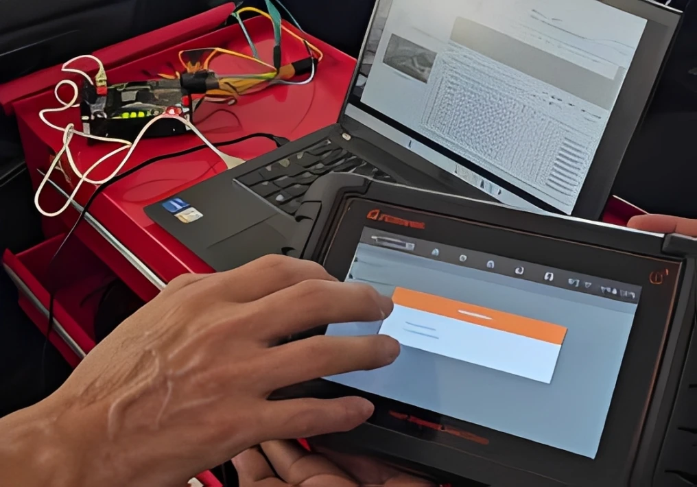 diesel mechanic using diagnostic laptop