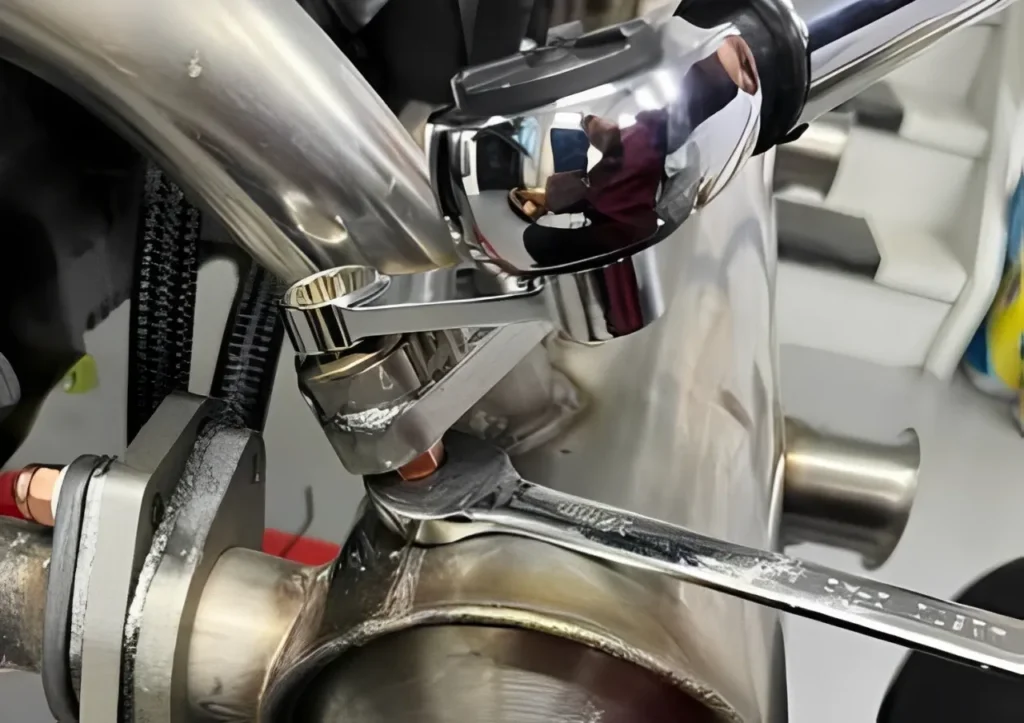 mechanic using a torque wrench on a diesel engine