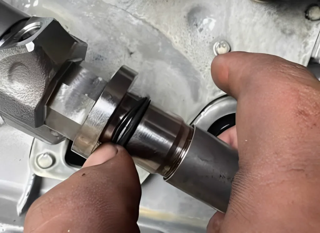 Mechanic installing a fuel system gasket kit on a diesel injector