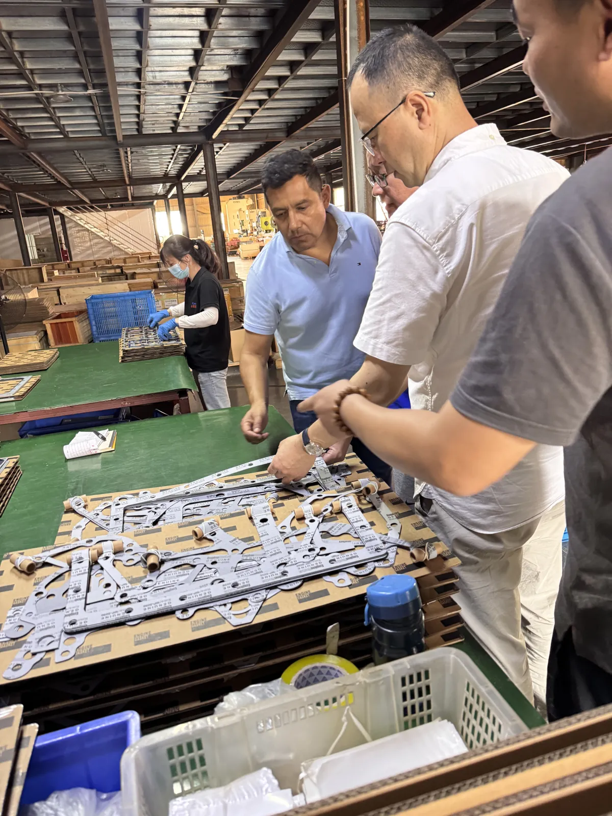 Visiting customers and our team discussing gasket kits at the workshop bench