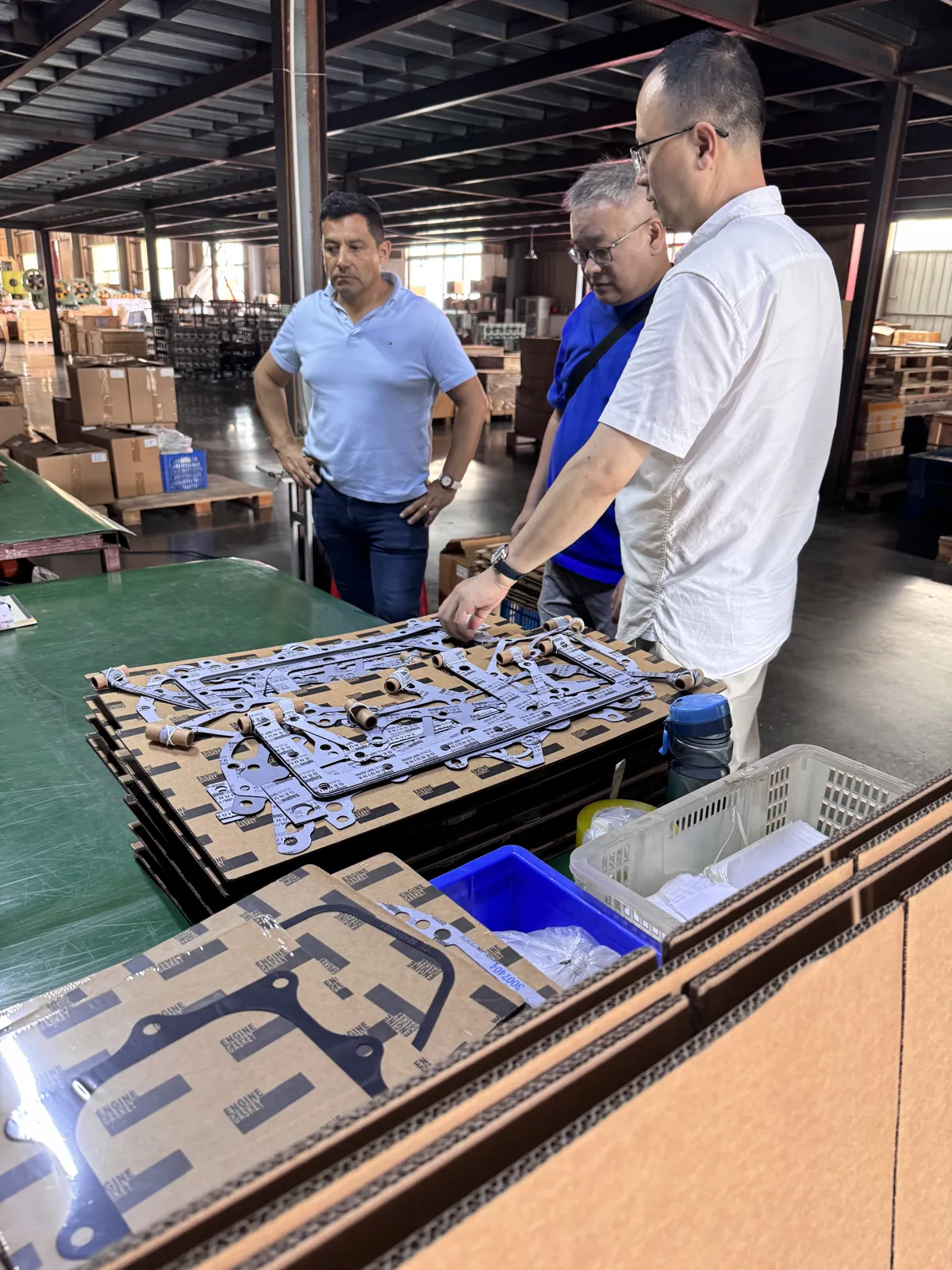 Our team explains gasket kits to visiting customers at the factory workbench