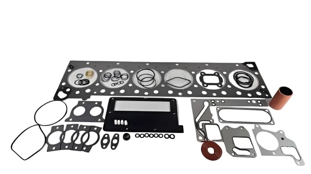 Quality inspector examining a batch of aftermarket Cummins MLS head gaskets for edge quality and coating integrity.