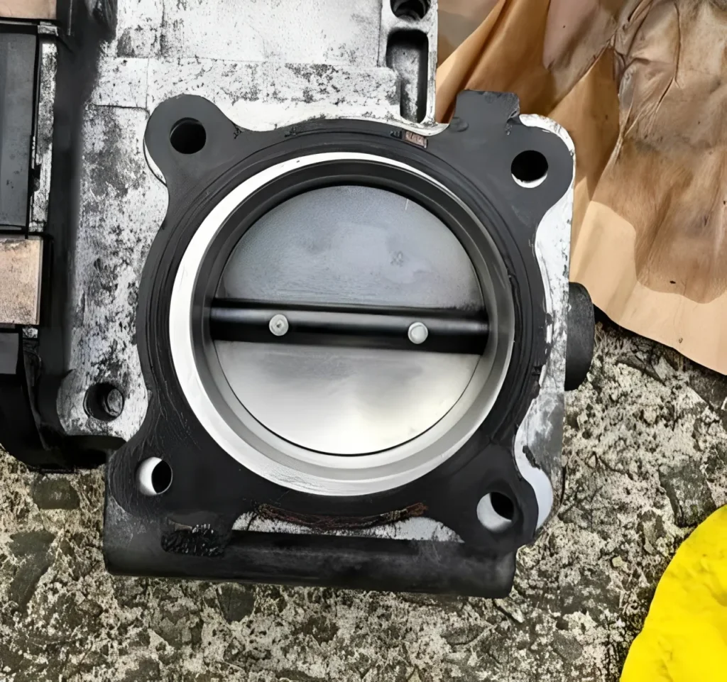 Throttle body flange cleaned for gasket inspection.